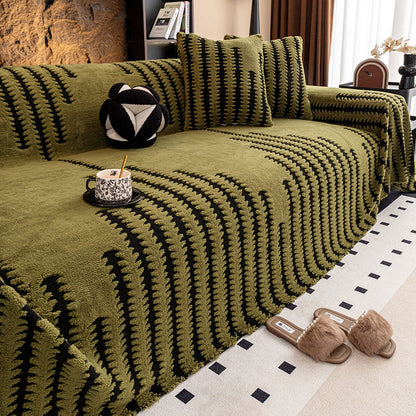 Olive green cover with black zigzag stripes on a sofa, with cushions, a teacup and slippers 11