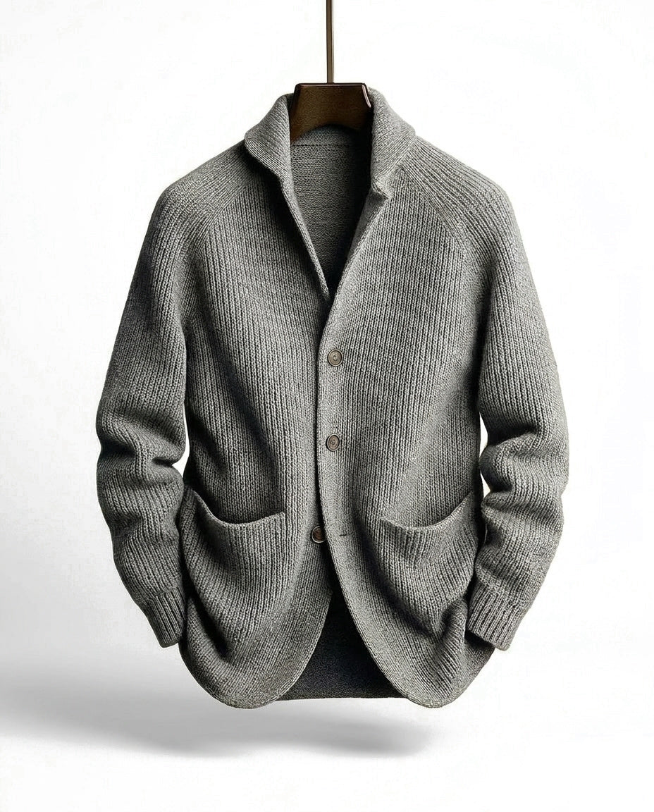 Grey ribbed cardigan on a wooden hanger, front view showing the shawl collar, button placket and two patch pockets. 4