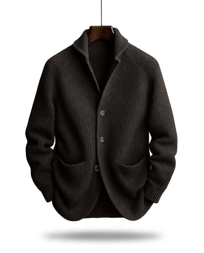 Charcoal-black version of the ribbed shawl-collar cardigan on a wooden hanger, showing three buttons and two front pockets. 2