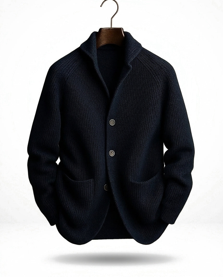 Navy ribbed cardigan with shawl collar and three buttons, hanging on a hanger with a curved hook, front view. 3
