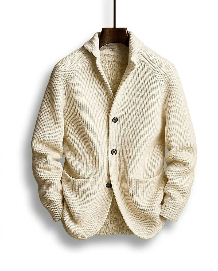 Cream ribbed cardigan hanging on a wooden hanger, front view with shawl collar, three buttons and two patch pockets. 5