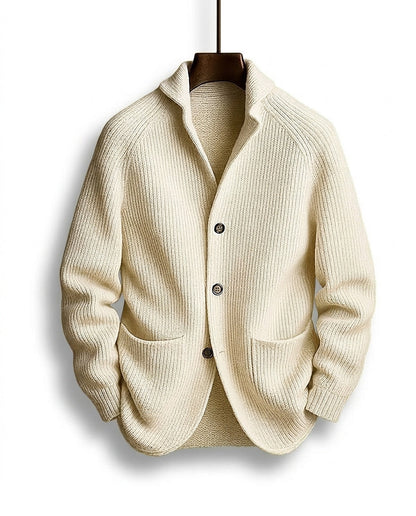 Cream ribbed cardigan hanging on a wooden hanger, front view with shawl collar, three buttons and two patch pockets. 5