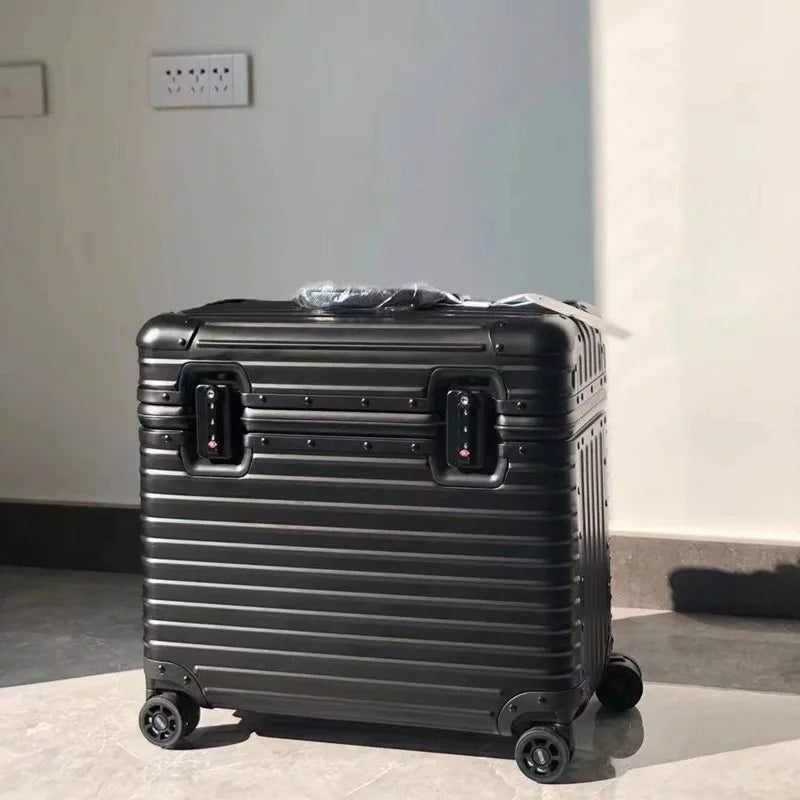 Black ribbed case with twin locks standing on a grey floor, plastic wrap still on the handle 10