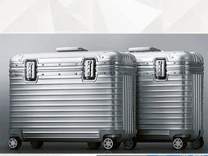 Two silver ribbed hard cases side by side in a studio, showing locks, corner guards and wheels 5