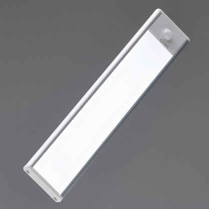 Close-up of a single light bar switched on against grey, showing the motion sensor and power button at one end. 7
