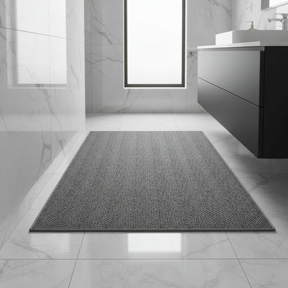 Grey textured mat on glossy white marble bathroom floor beside a black wall-hung vanity unit 1