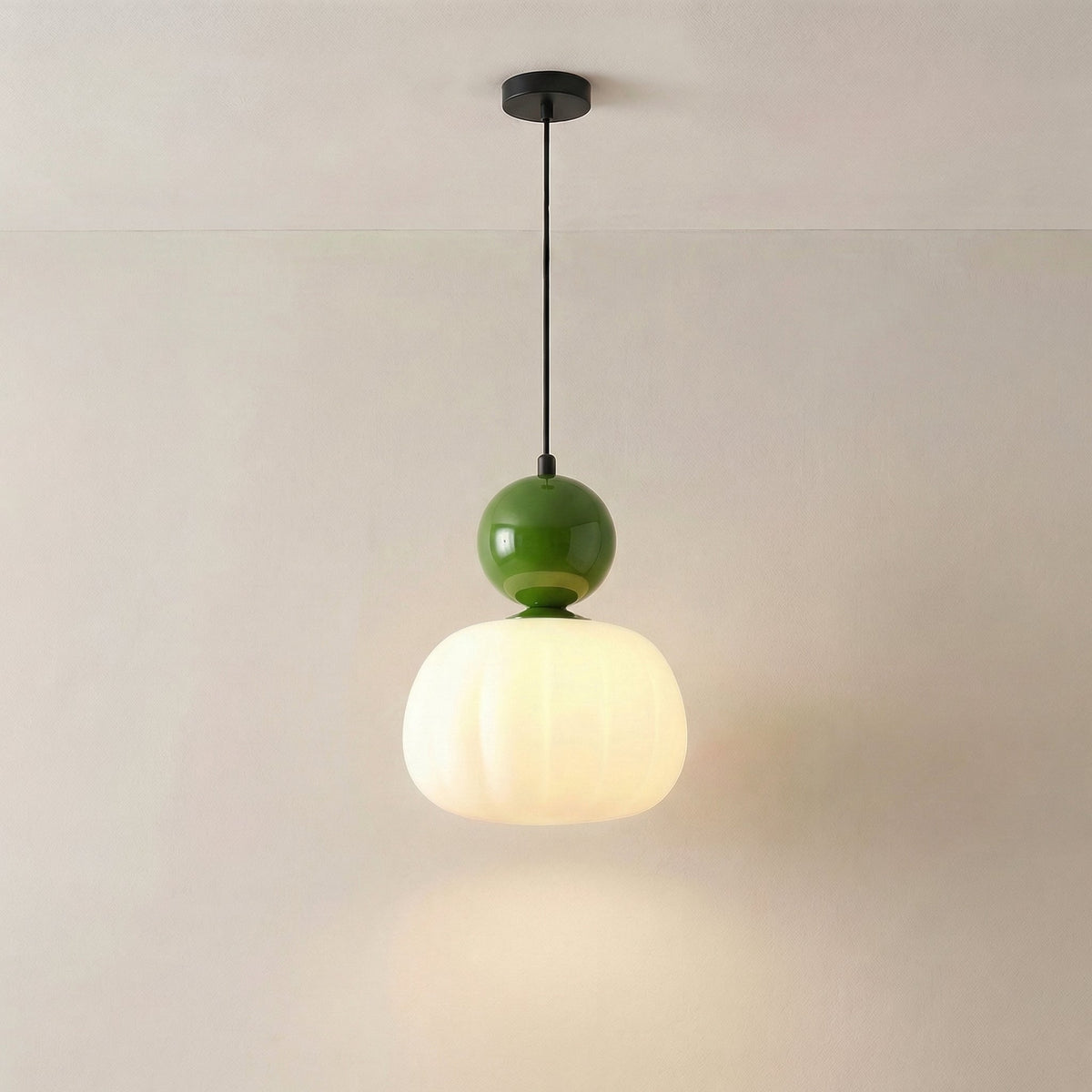 Single pendant with a deep green cap hanging from a black ceiling canopy, switched on 5