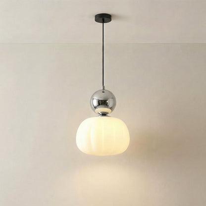 Single pendant with a mirrored chrome cap and glowing fluted shade on a black canopy 6