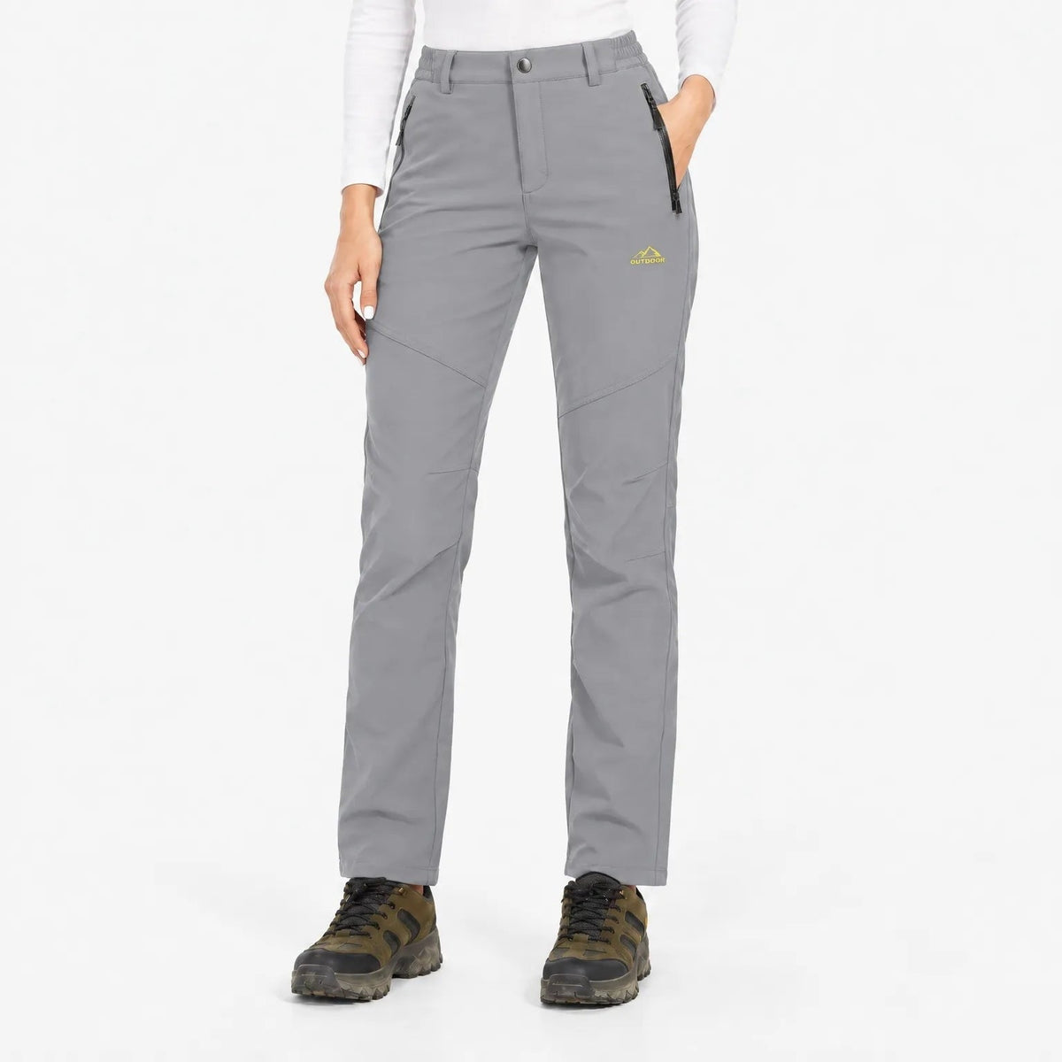 Light grey trousers worn with hiking boots, front view showing elasticated waistband and zipped pockets 9