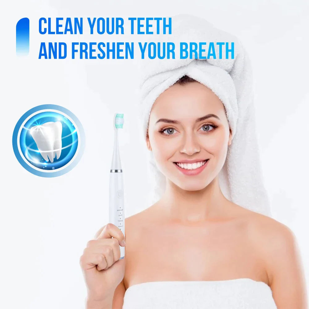 Smiling woman with a towel wrapped around her hair holding the white electric toothbrush with a green-tipped brush head, with a tooth graphic beside her. 1
