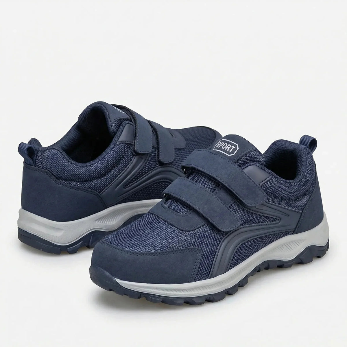Pair of navy double-strap shoes with grey soles, one shoe tilted to show the heel and opening 9
