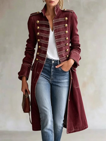 Model wearing the coat in a deep burgundy finish, open over a white top and jeans, with gold buttons and pale braided trim. 11