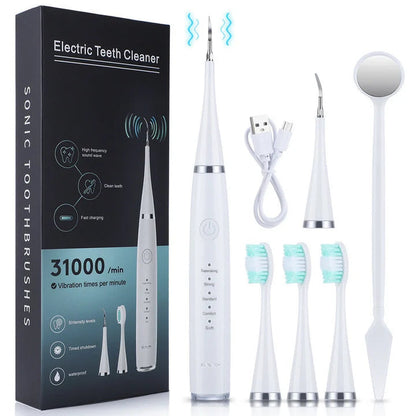 White cleaner set laid out beside its black box: scaler handle, charging cable, scaler head, three brush heads and a dental mirror. 4