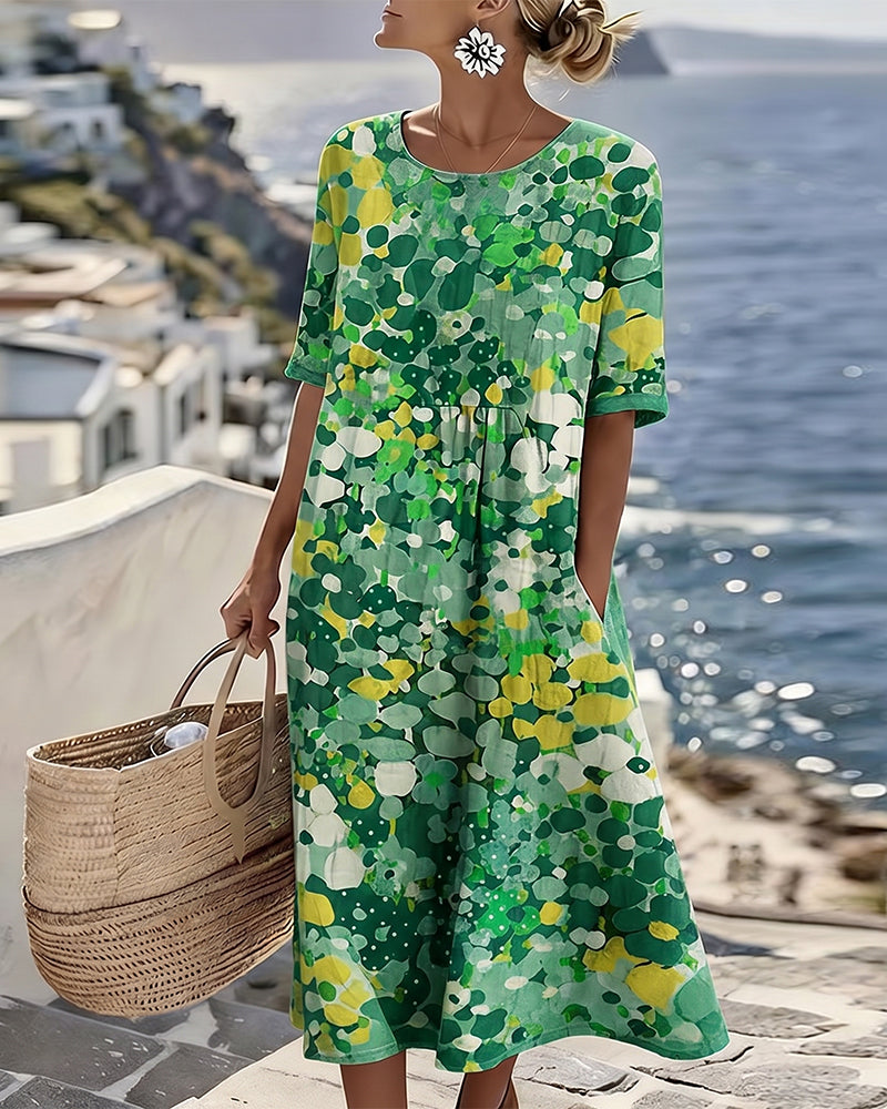 Model wearing the green and yellow floral midi dress, carrying a woven basket by the sea 5