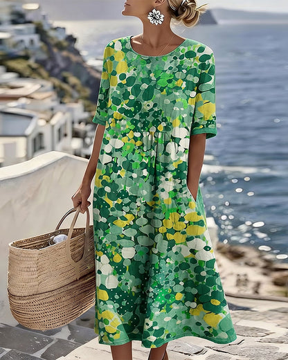 Model wearing the green and yellow floral midi dress, carrying a woven basket by the sea 5
