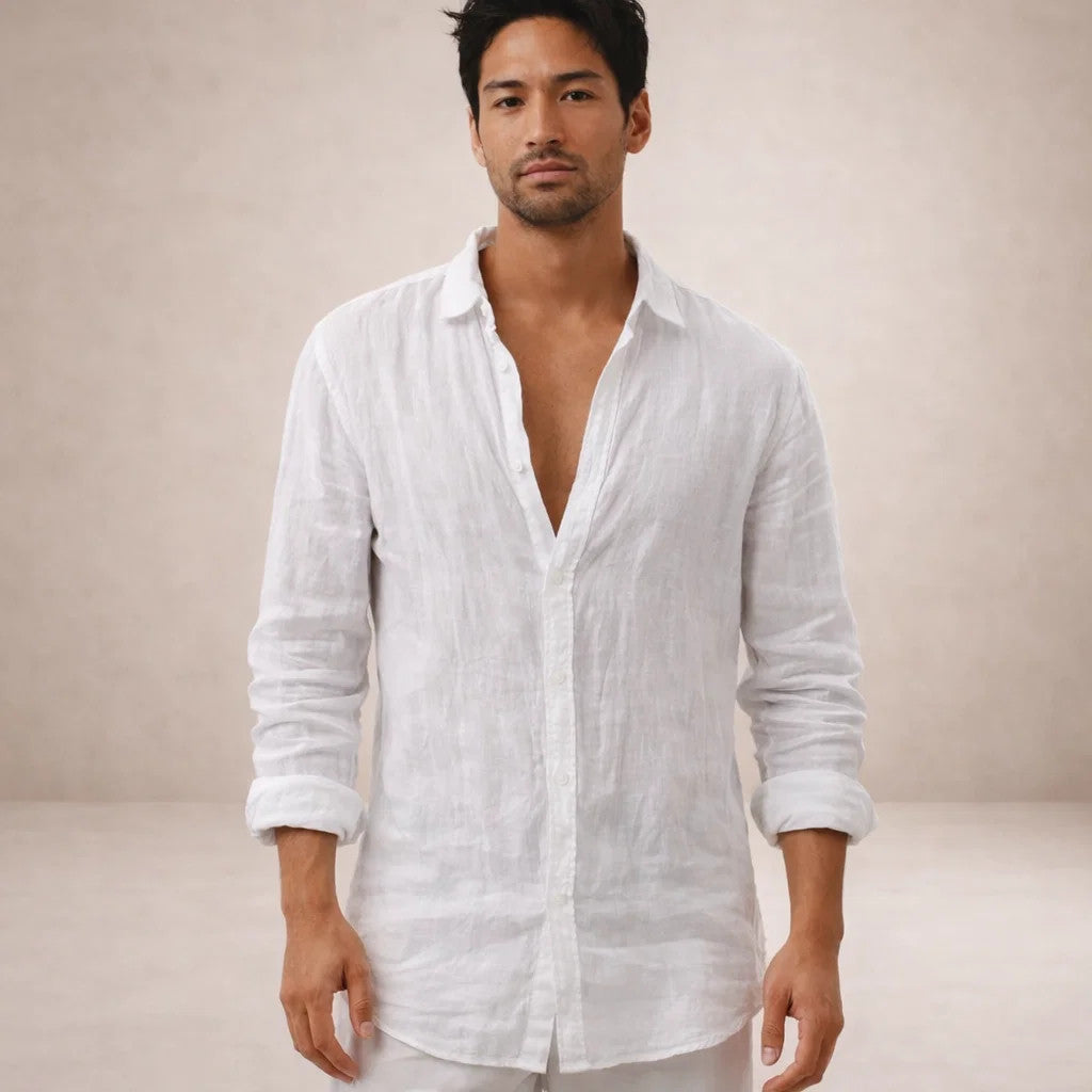 Model facing the camera in a white linen shirt, collar open, sleeves rolled, standing against a soft neutral backdrop. 9