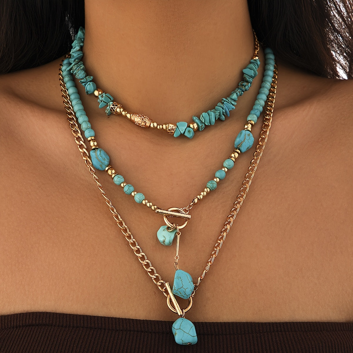 Model wearing the layered turquoise bead and gold-tone chain necklaces, shown in a close crop of the neckline 6