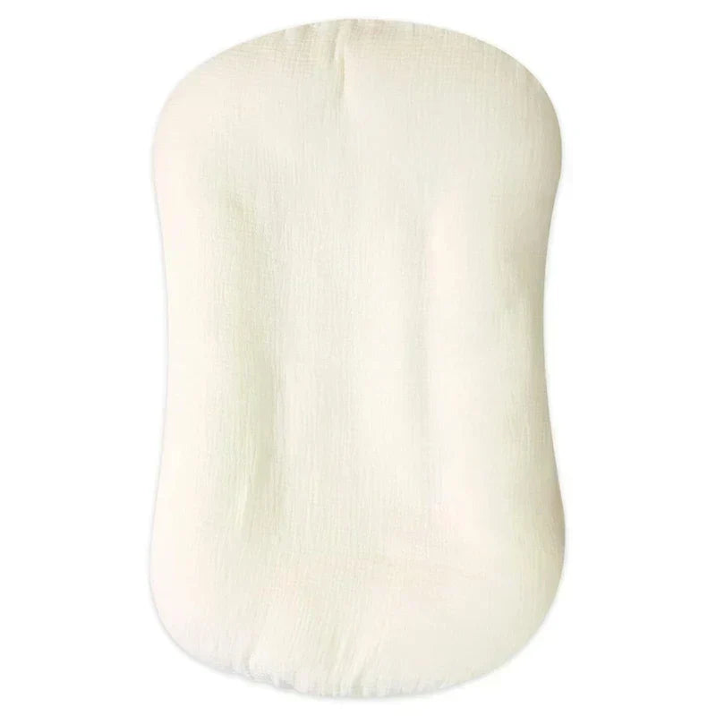 Empty cream crinkled-muslin lounger photographed from above on a plain white background 10