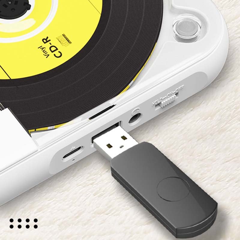 Close-up of the player's side showing a black USB stick plugged into the port, next to the charging and headphone sockets. 9