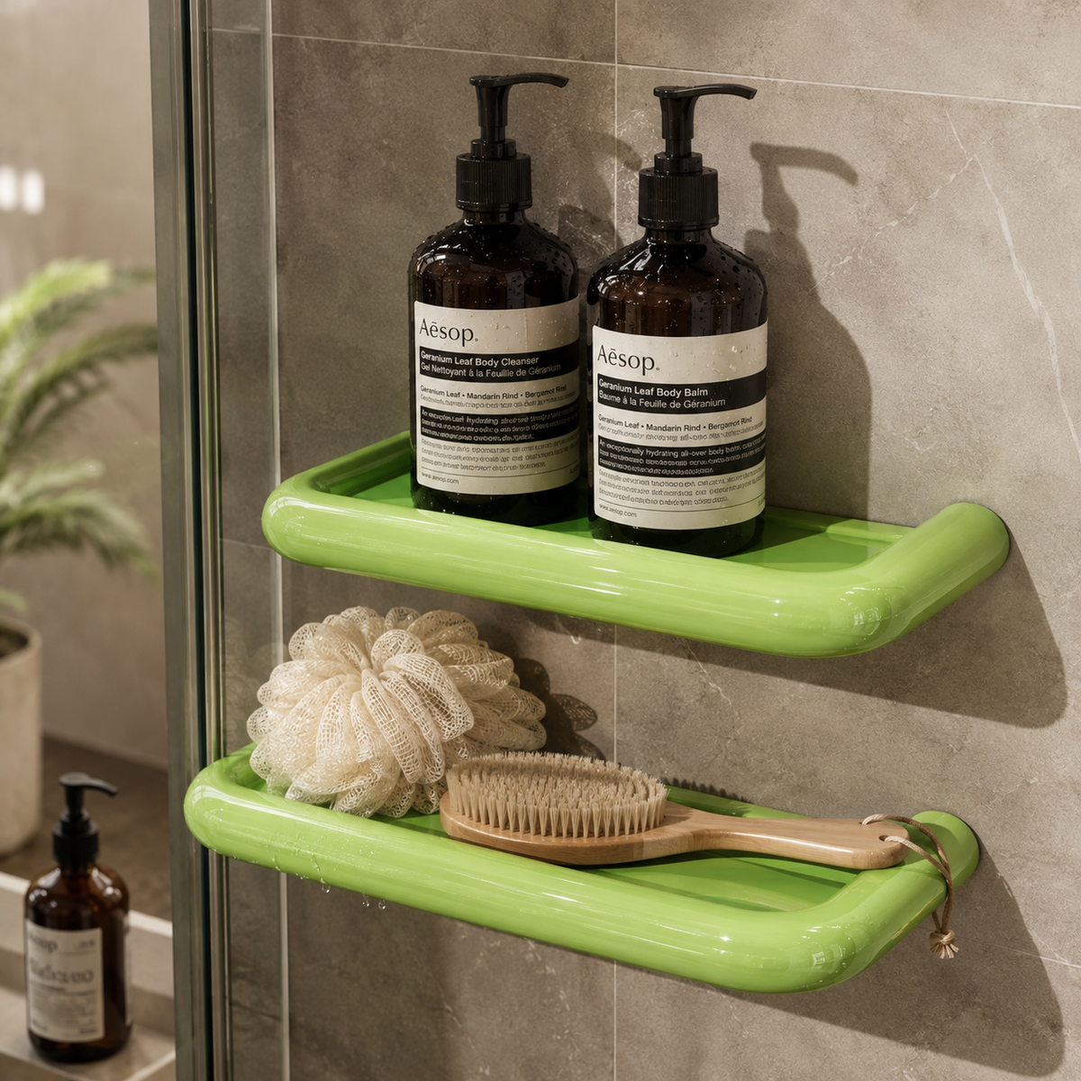 Two bright green shelves fixed to grey stone-effect shower wall, holding pump bottles, a sponge and a brush 6