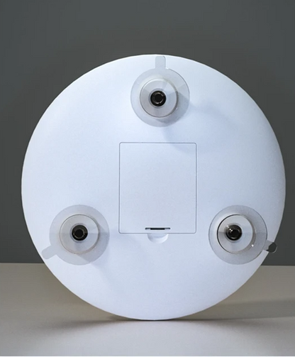 Back of the white round mirror showing three suction cups and a battery compartment cover 3
