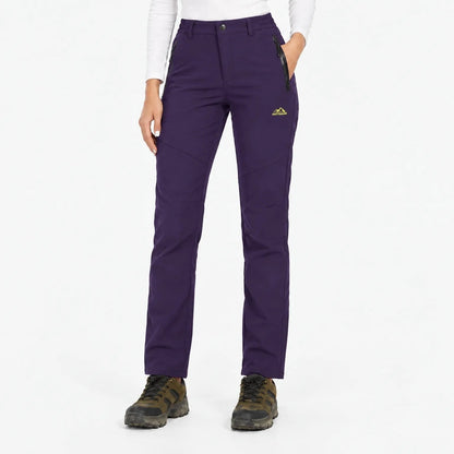 Deep purple trousers worn with hiking boots, front view showing zipped pockets 16