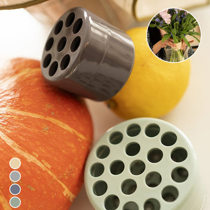 Small grey insert with nine holes and larger green insert with many holes beside a pumpkin and lemon, with colour swatches and a bouquet inset. 11