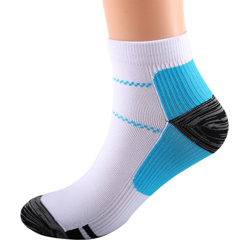 Single white ankle sock worn on a leg, side view showing blue heel and arch panels, dark grey heel and toe, and blue wavy stripes. 5