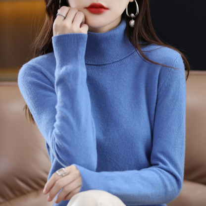 Model in a bright blue roll-neck jumper with a folded ribbed collar, one hand resting against her chin. 3