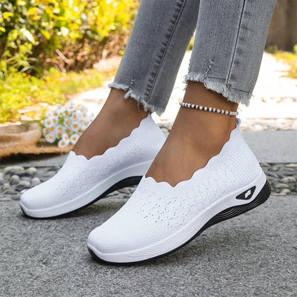 White knit slip-on shoes with scalloped edges and thick soles, worn outdoors with frayed jeans and a beaded anklet 21