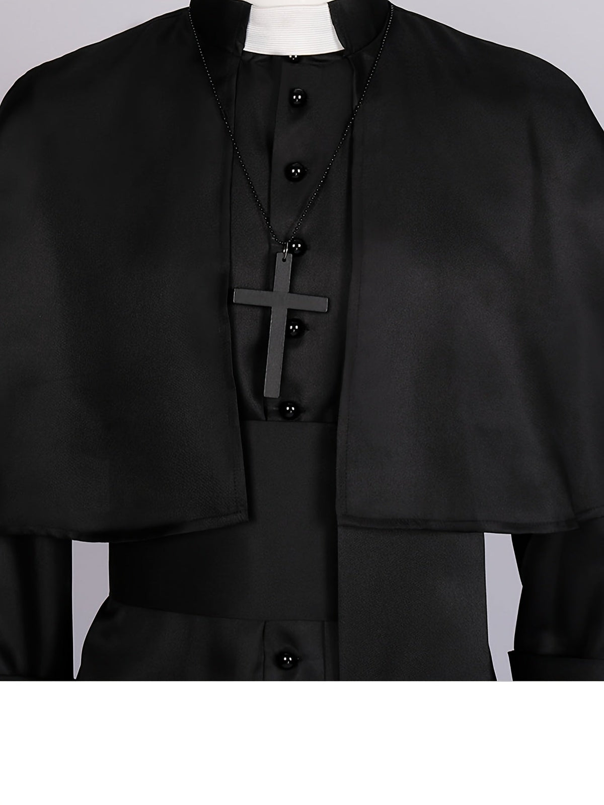 Close-up of the white collar tab, black buttons and wooden-style cross pendant on a beaded chain 7