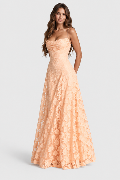 Front view of a model in a peach daisy lace gown with draped neckline, fitted waist and long flared skirt. 16