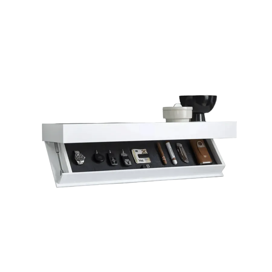 White floating shelf with the front flap open, revealing a dark lining holding a watch, keys, cash, a cigar and a pocket knife. 2