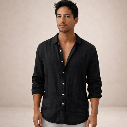 Model facing the camera in a black linen shirt with white buttons, open collar and sleeves rolled up. 10
