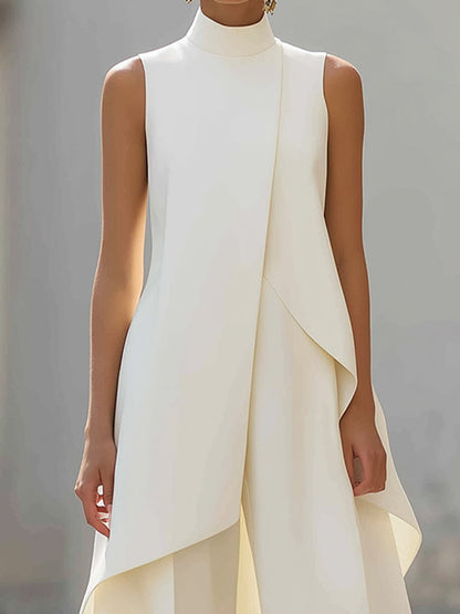 Close-up of the cream top's high neckline, diagonal overlapping panel and curved asymmetric hem. 11