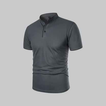 Angled three-quarter view of the dark grey polo showing the black buttons and placket 15