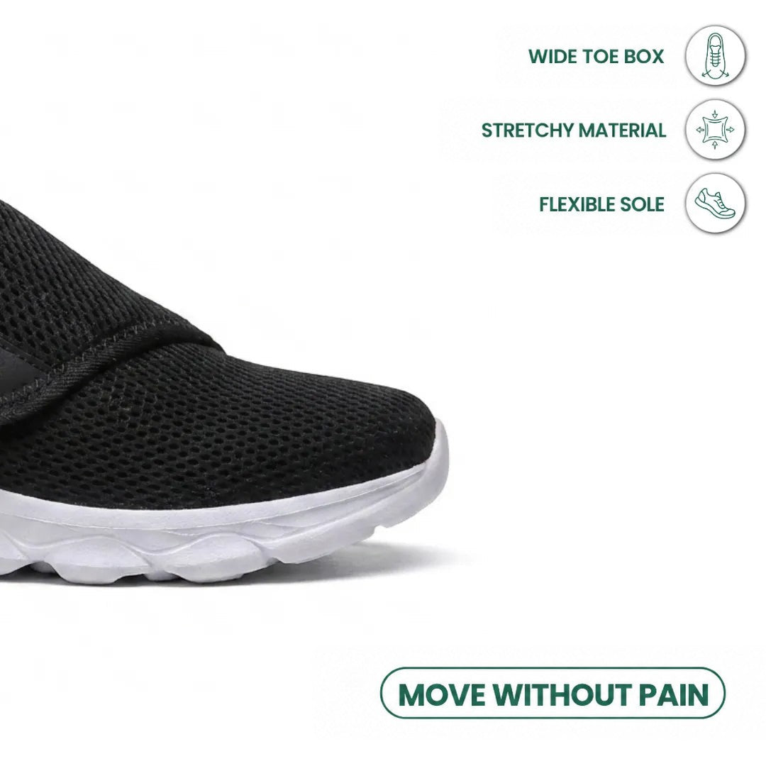 Close-up of the broad toe box of the black mesh shoe, with icons for stretch material and flexible sole. 23
