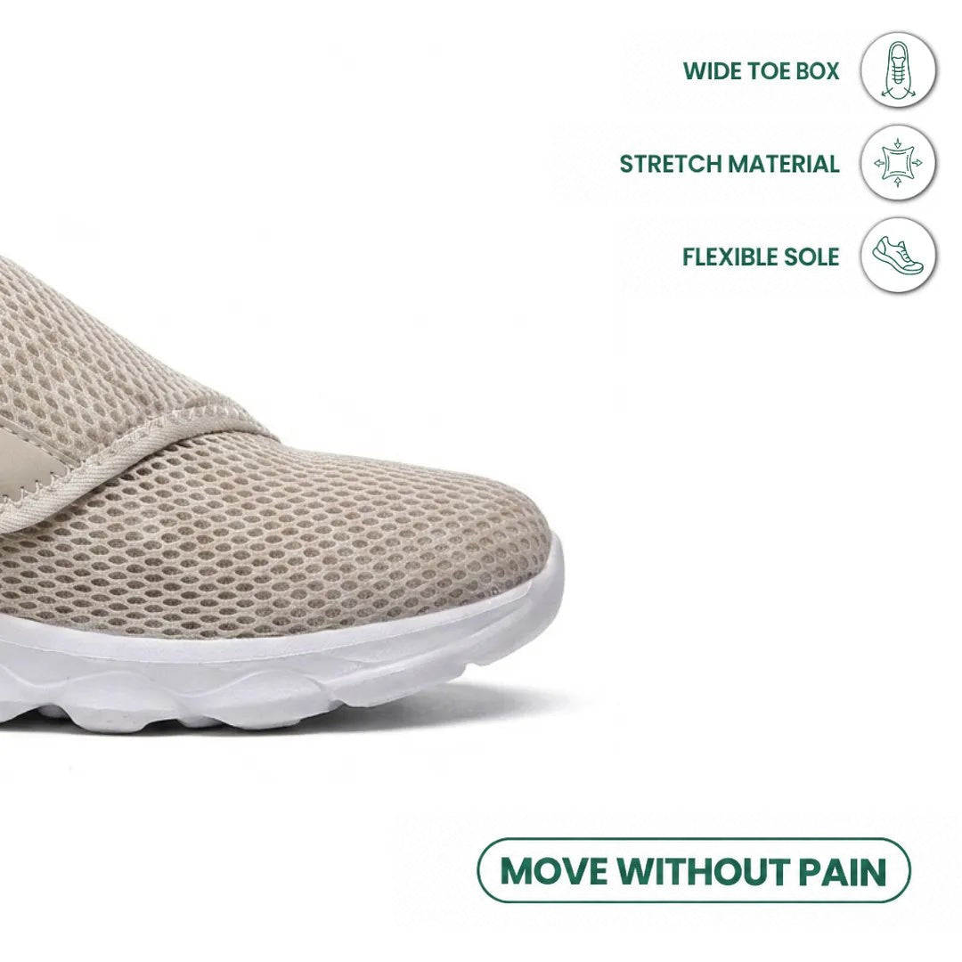 Close-up of the broad toe box of the beige mesh shoe, with icons for stretch material and flexible sole. 32