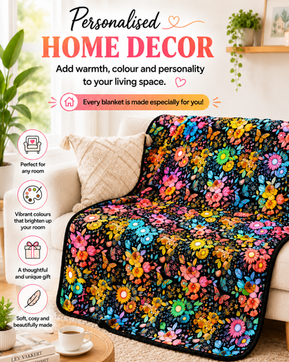 Blanket coloured in with bright flowers and butterflies, draped over a cream sofa in a sunny living room 2