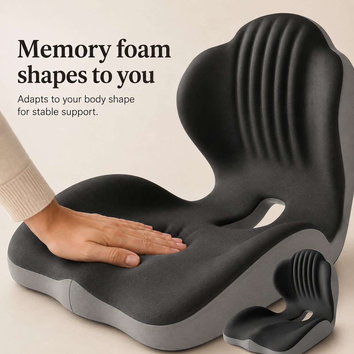 Hand pressing into the dark grey memory foam seat, showing how it moulds; small second cushion at corner 3