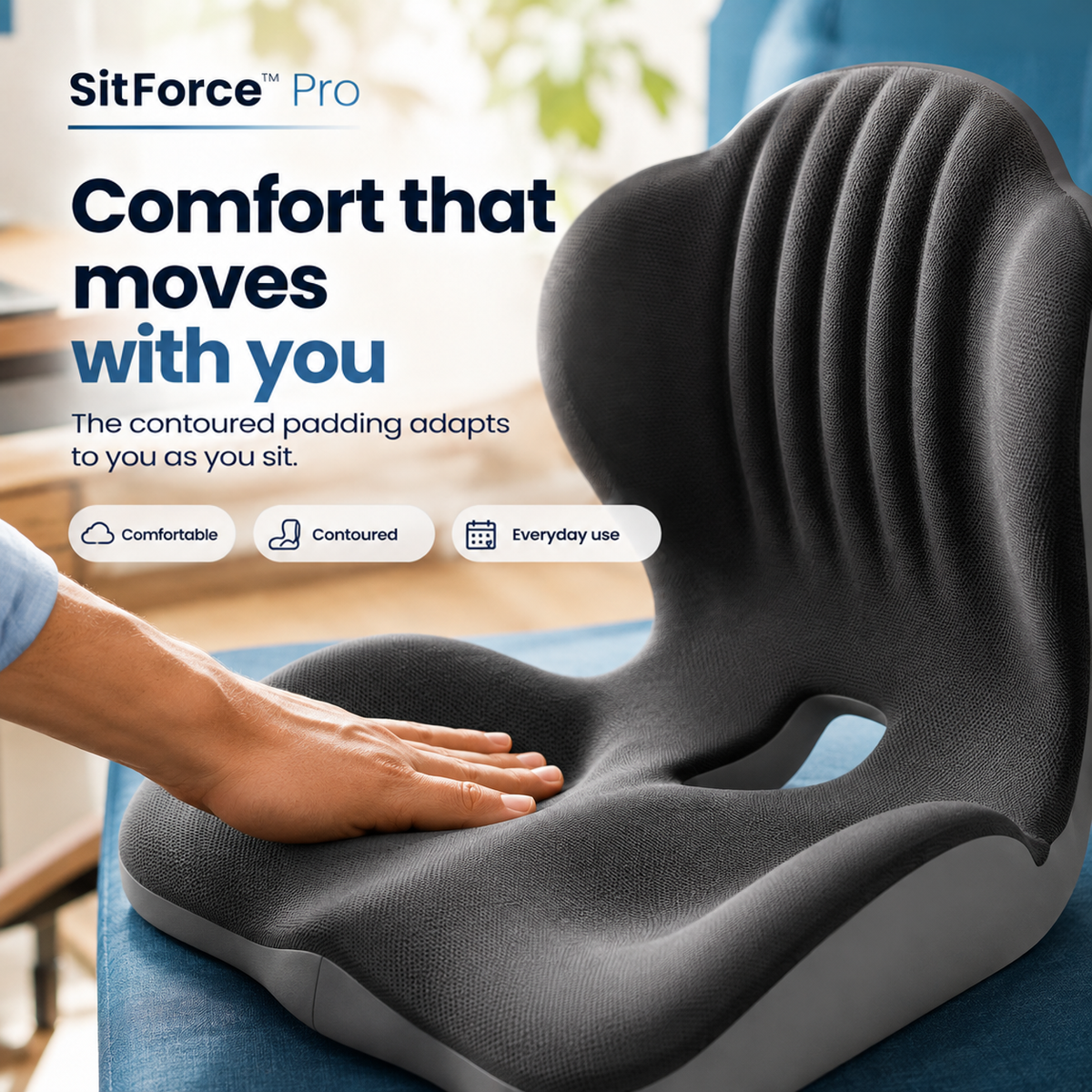 Hand pressing the textured dark grey seat of the cushion, which sits on a blue chair 14