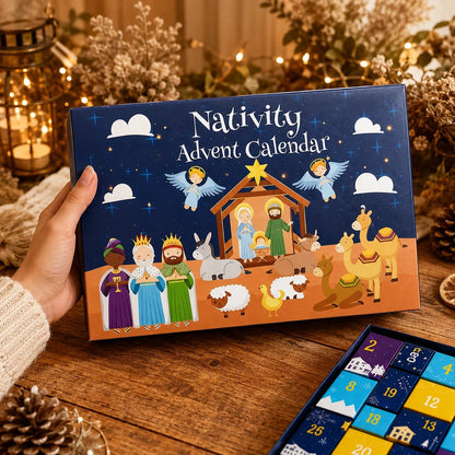 Hand holding the illustrated navy box lid with nativity scene artwork, open tray of numbered doors beside it 4