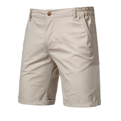 Front view of beige knee-length shorts with a single brown button, side pockets, belt loops and turned-up hems. 1