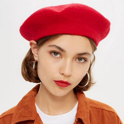 Red wool beret worn by a model with an orange corduroy jacket, front view 21