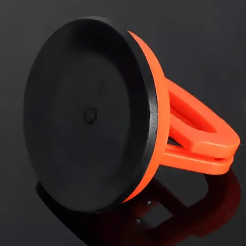 Underside of an orange suction puller showing the flat black rubber cup that grips the car body. 3