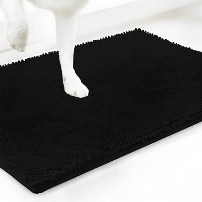 Black chenille mat shown at an angle with a white dog's paw stepping onto the pile, on a white background. 19