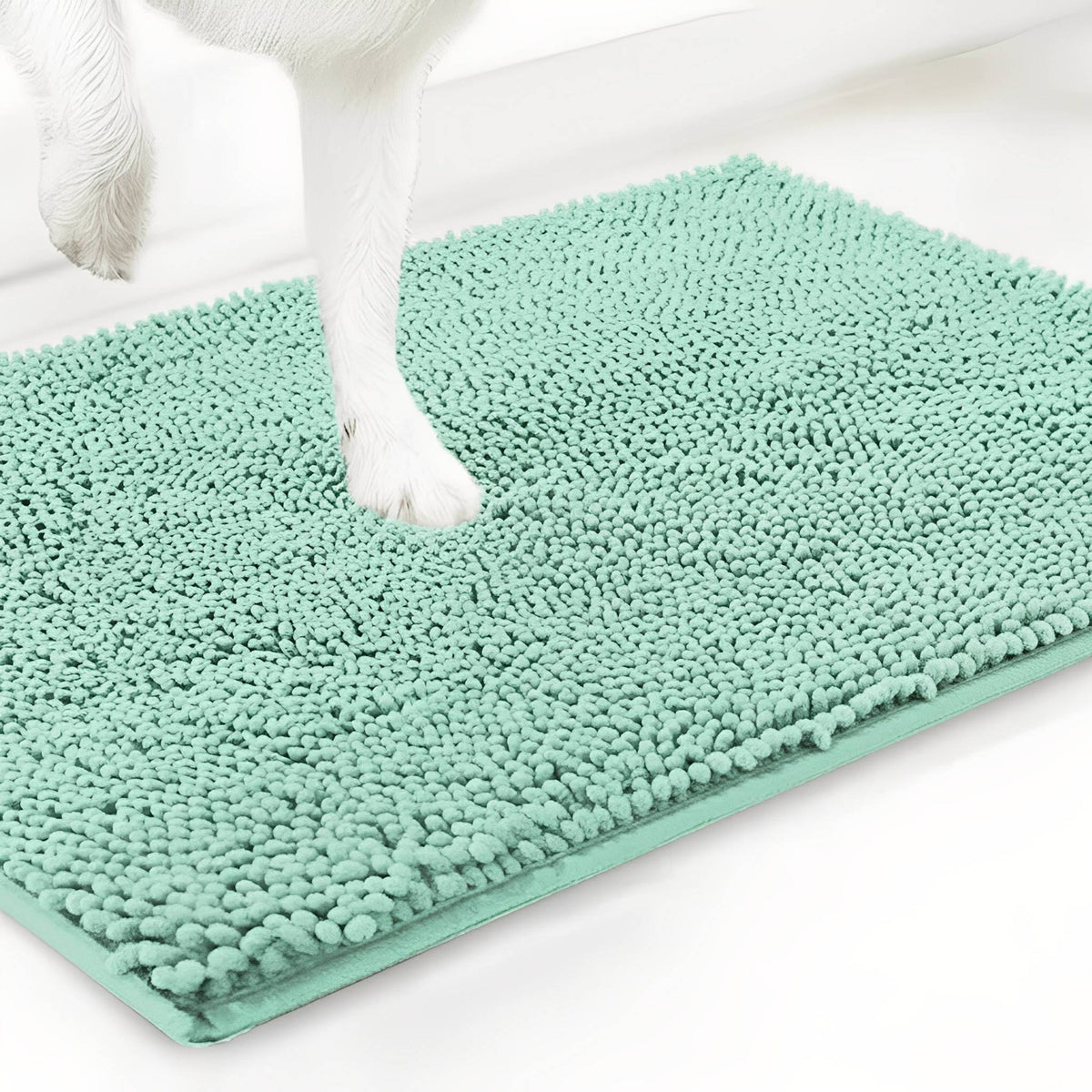 Pale mint green chenille mat shown at an angle with a white dog's paw pressed into the pile, on a white background. 15