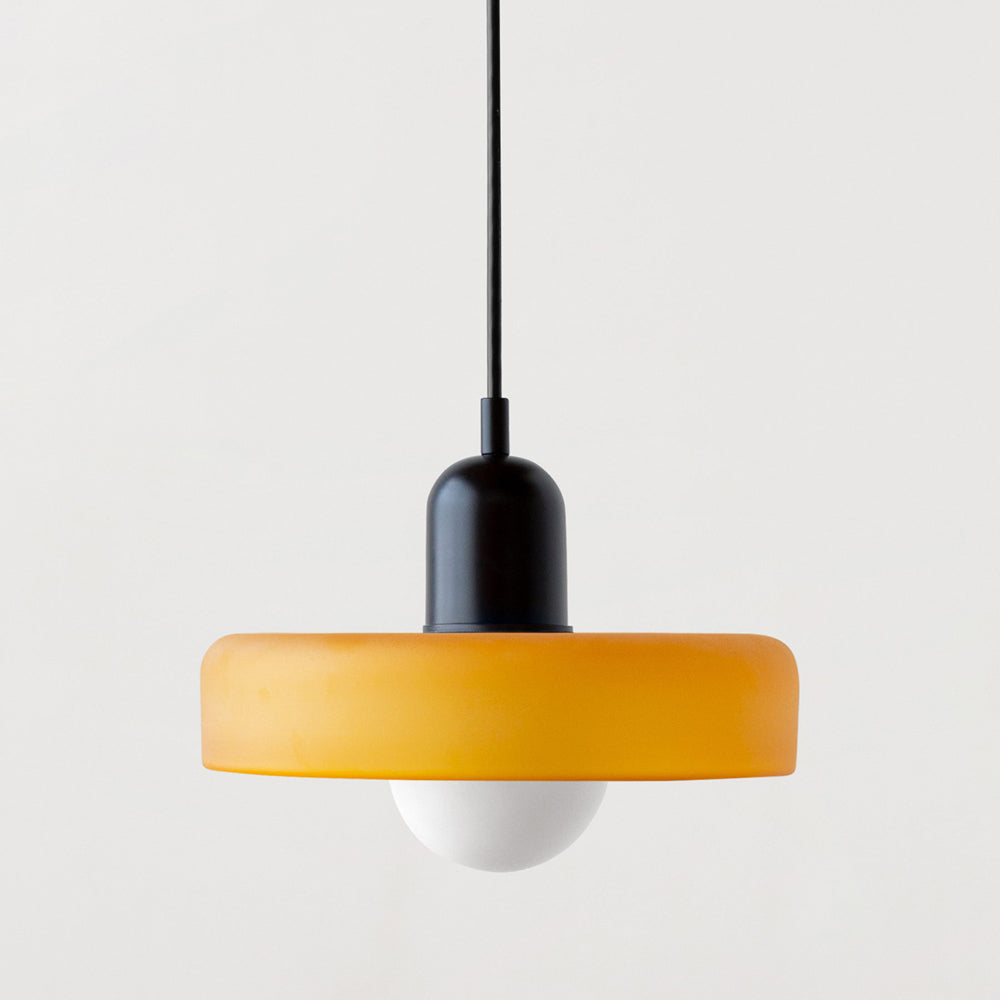 Close view of a yellow frosted glass pendant with a matt black cap and round bulb 25