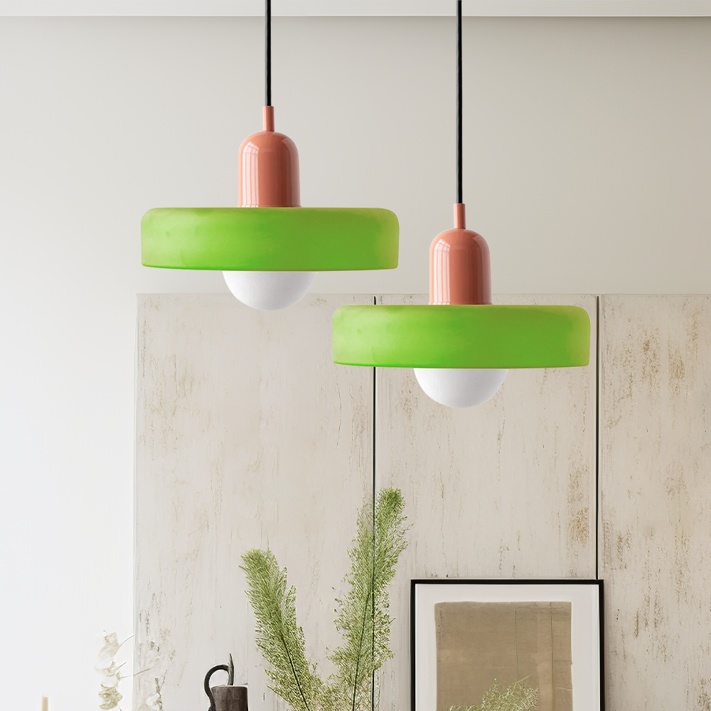 Two lime green pendant lamps with coral caps hanging at different heights in a room 51