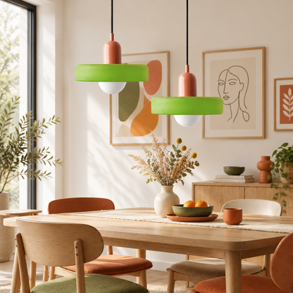 Two pendant lamps with green glass shades and coral caps hang above a wooden dining table 1